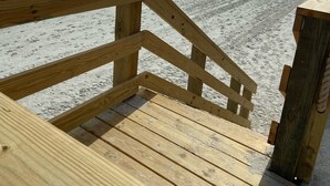 A wooden staircase leading to a beach with a clear view of the ocean. - Oceanfront Paradise Awaits You! Walk directly to the beach from property (New Smyrna Beach)