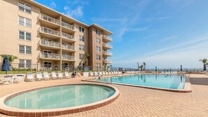 A hotel with a pool area, multiple balconies, and a view of the ocean. - Oceanfront Paradise Awaits You! Walk directly to the beach from property (New Smyrna Beach)