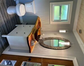 Bathtub, hair dryer, towels, toilet paper