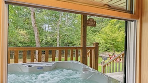 A hot tub with a wooden deck and a sign that reads "The Porch".