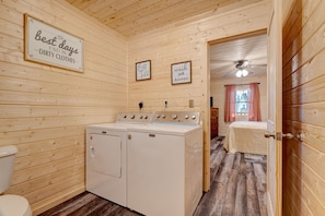 Enjoy a convenient laundry experience with a washing machine and dryer in this cabin's compact laundry room.
