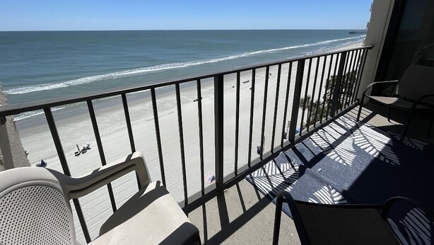 A balcony with a view of the beach and ocean. - Horizon East 704 - Oceanfront in Garden City Beach, SC (Garden City)