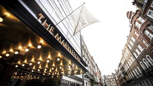 A hotel facade with a modern design, featuring a prominent sign and a patterned flag. - Relaxing Studio Double Bed At Marylebone (London)