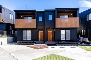 A modern residential building with a symmetrical facade, large windows, and a flat roof. - Mt. Fuji Resort Club-RIN- (Fujikawaguchiko)