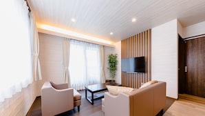 A modern living room with a sofa, armchair, and a coffee table. - Mt. Fuji Resort Club-RIN- (Fujikawaguchiko)