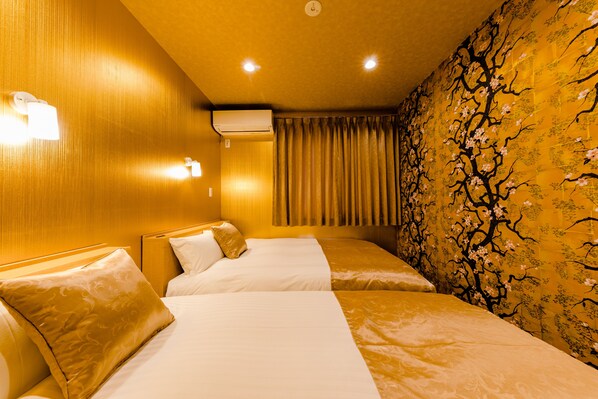 A hotel room with two beds, a wall-mounted air conditioner, and a curtain. - Mt. Fuji Resort Club-MIYABI- (Fujikawaguchiko)