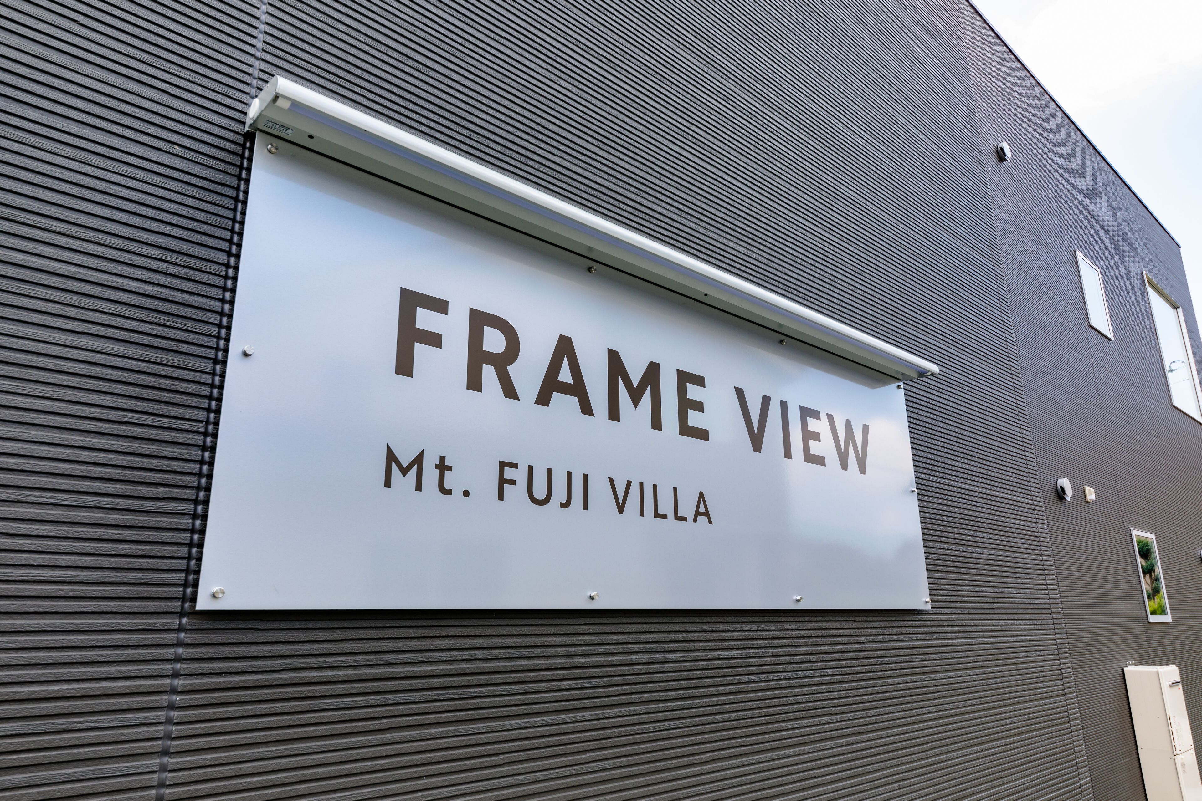 A sign for "FRAME VIEW Mt. FUJI VILLA" on a building.