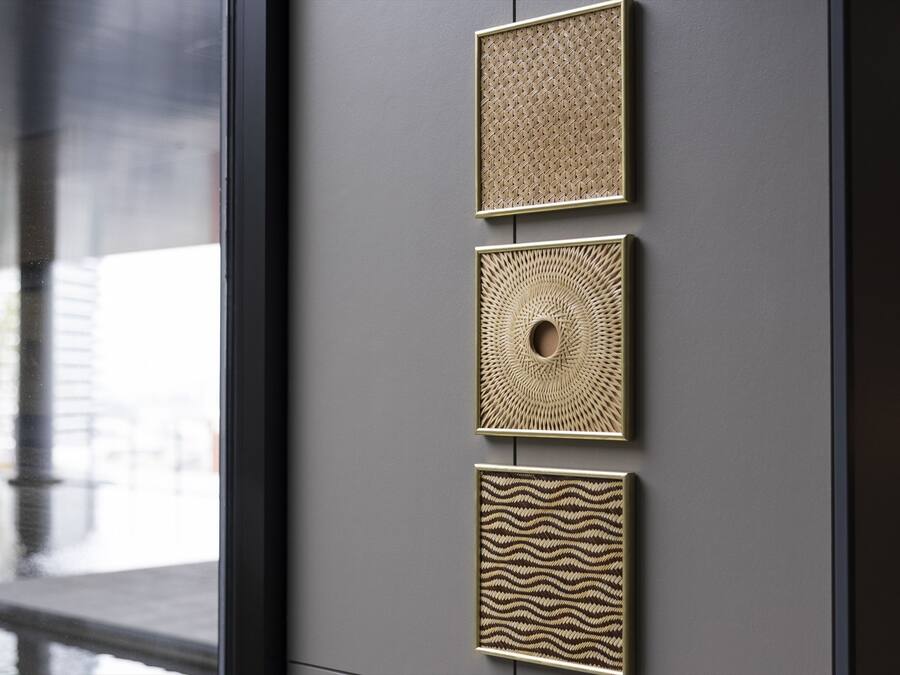 A wall with four textured panels in a modern interior.