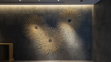A modern interior with three wall-mounted light fixtures featuring a sunburst design.