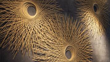 A close-up of a woven bamboo structure with circular openings.