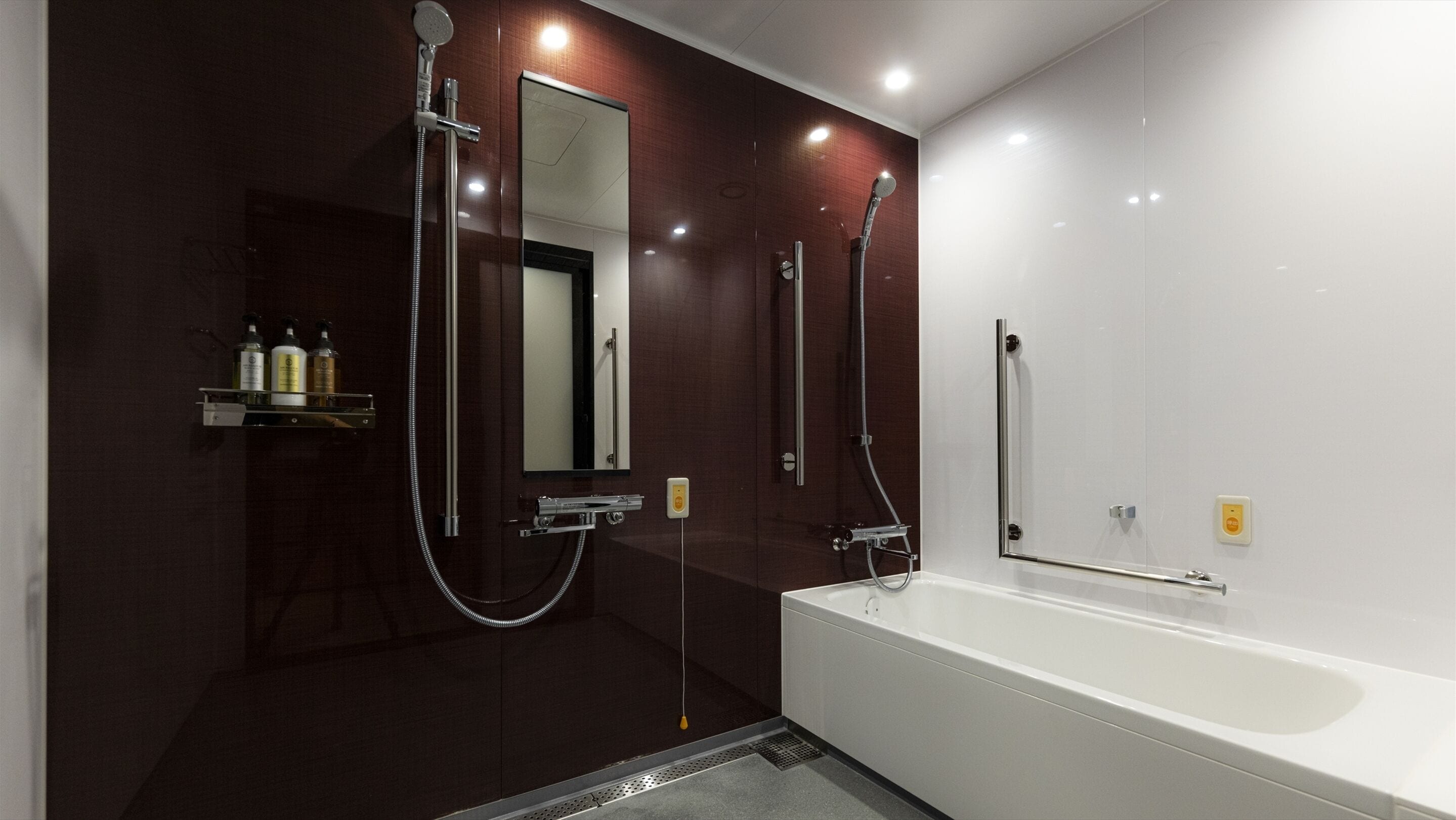 A modern bathroom with a large bathtub, a walk-in shower, and a mirror.