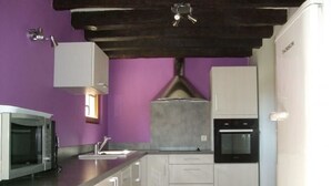 A modern kitchen with white cabinets, a built-in microwave, and an oven. - Charming Cottage: 3BR, Cozy Fireplace, Large Garden, Near Bercé Forest (Saint-Mars-d'Outillé)
