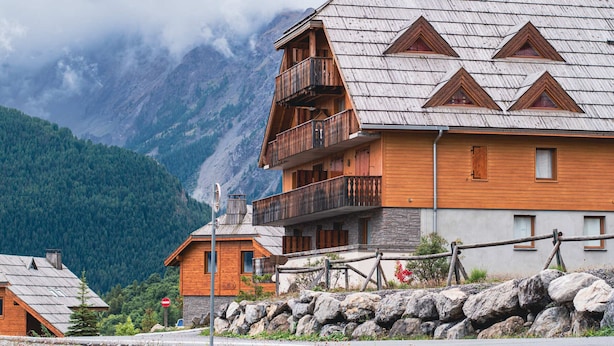 A wooden chalet with a balcony, set against a mountainous backdrop. - Studio for 4 with balcony and parking in Pra Loup 1500 (Uvernet-Fours)