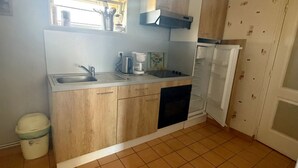 A compact kitchen with a sink, a coffee maker, and a refrigerator. - Charming Country House with Garden, Terrace, Petanque & Fireplace Near Vernie (Vernie)