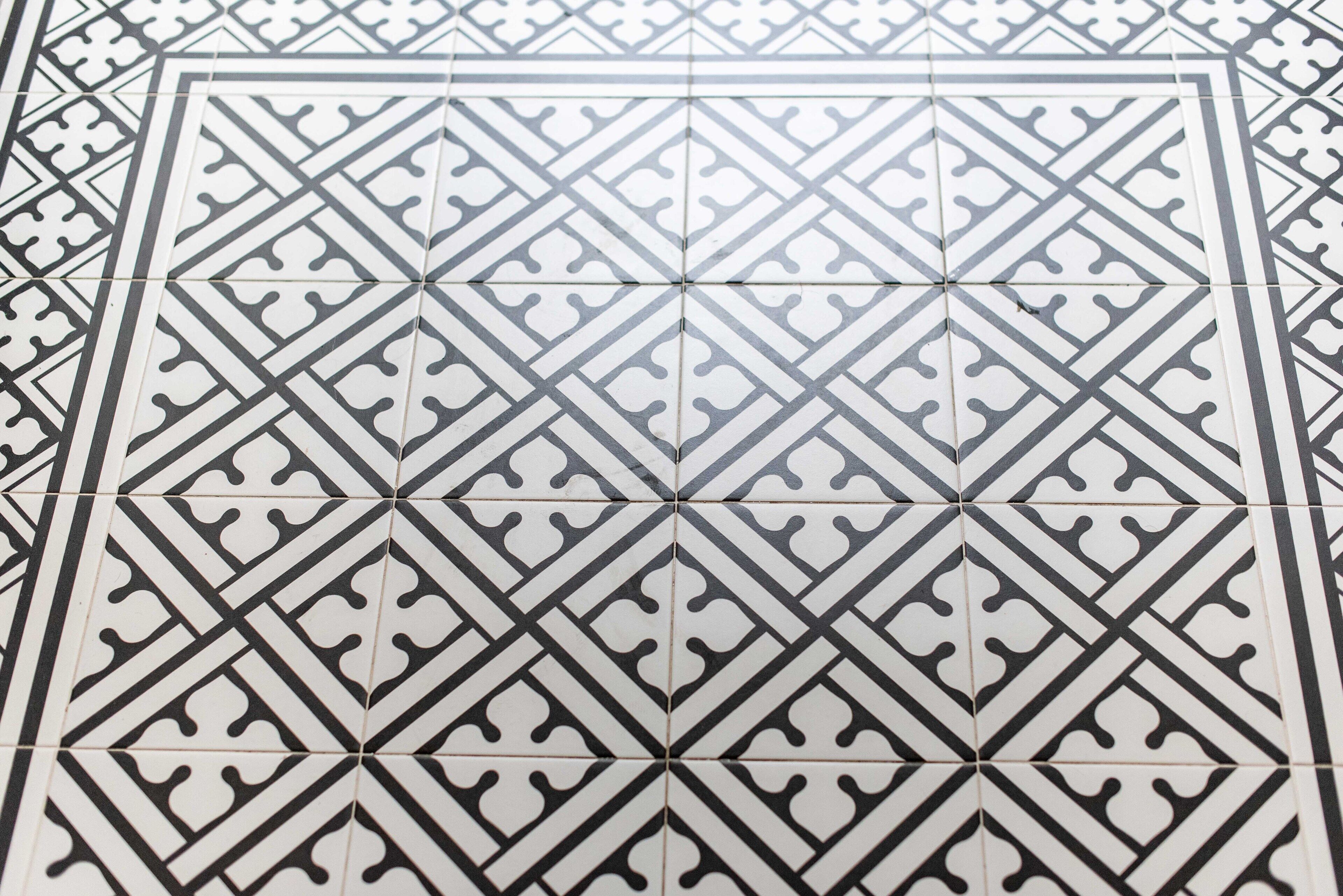 A tiled floor with a geometric pattern.