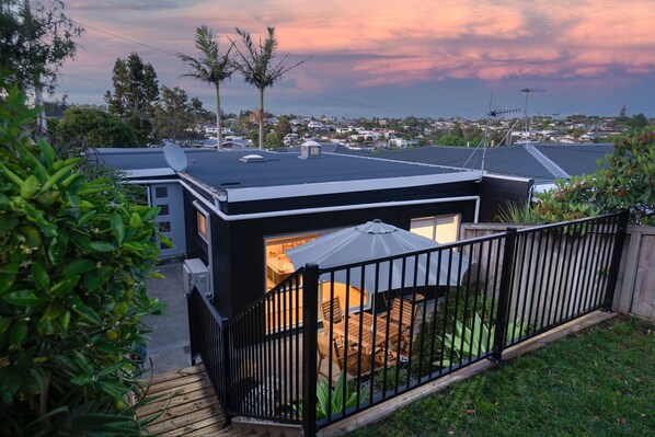 A residential property with a fenced backyard, satellite dish, and a view of the neighborhood.