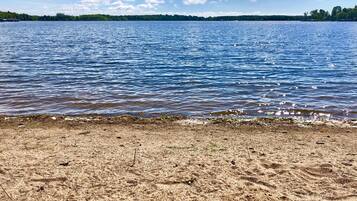 Enjoy a serene lakeside retreat with access to a sandy beach.