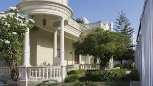 A classical building with a central dome, columns, and a balcony.