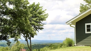 A house with a view of a green landscape and mountains in the distance. - Gorgeous Mountain View,  6 Private acres, Close to Downtown! (Hot Springs)