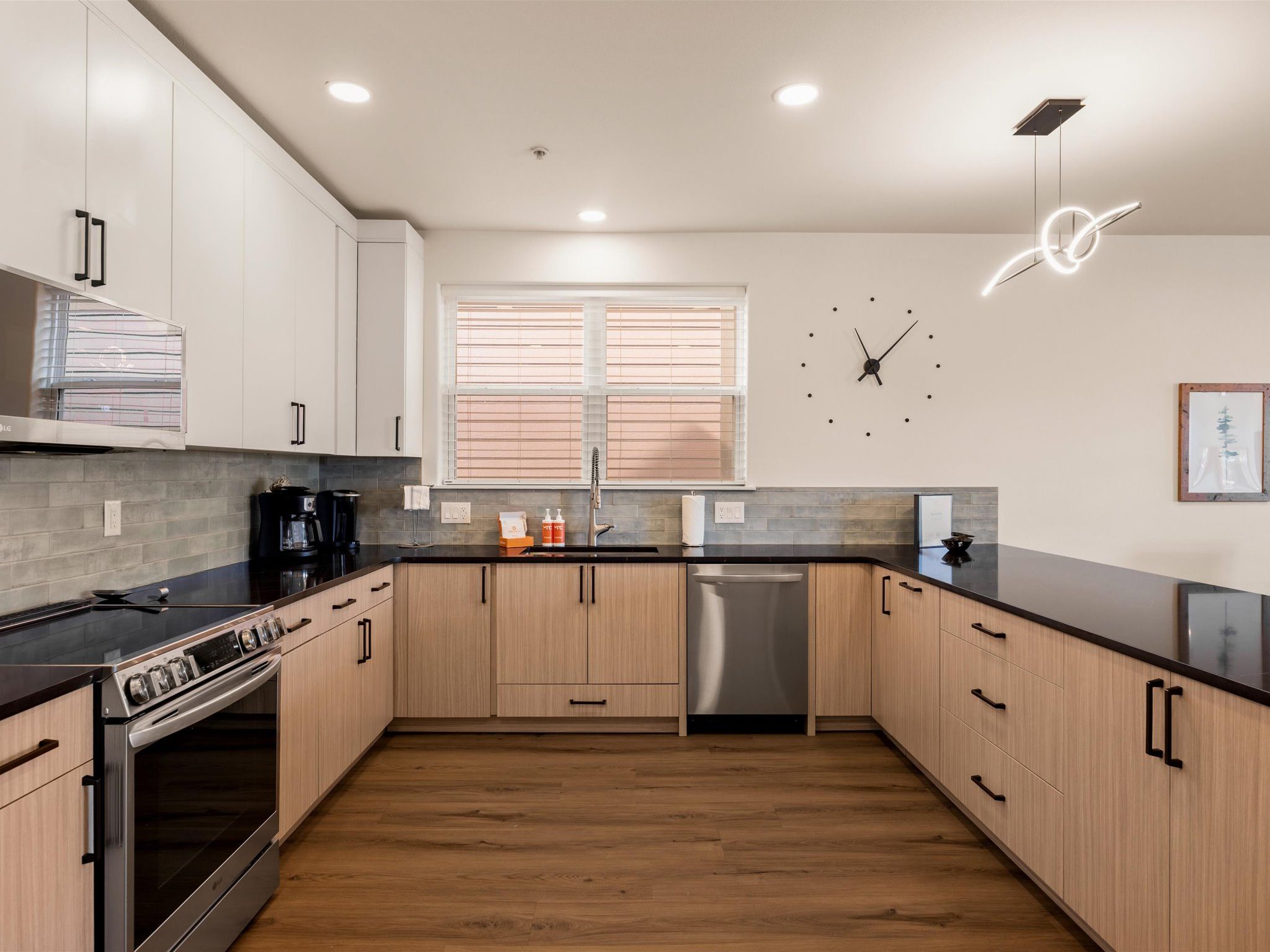 Large, open kitchen with high-end appliances and breakfast bar seating for four.