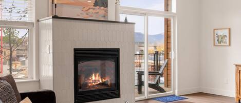 Family room with large, comfy sectional couch, huge TV (Netflix & Sling provided), and fireplace.