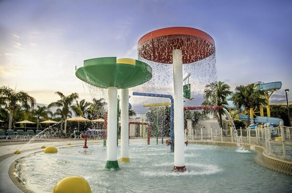 A water park with multiple water features, including fountains and water slides.