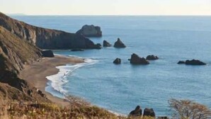 A coastal landscape with rocky outcrops and a sandy beach. - The Solterra | Wine Country 5BR, Views, EV, Games (Santa Rosa)
