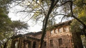 A stone building with a traditional architectural style, surrounded by trees. - The Solterra | Wine Country 5BR, Views, EV, Games (Santa Rosa)