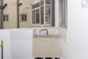 A small, white bathroom with a sink and window. - MIRALMAR, 10º-69 (Cullera)