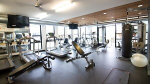A gym with treadmills, elliptical machines, and weightlifting equipment. - Urban Condo with Balcony in Downtown Ann Arbor (Ann Arbor)