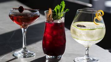 Three different types of drinks in glasses on a table.