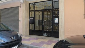 A building entrance with a black gate and the name "Edificio Mari Carmen" above it. - MARI CARMEN, 2º-8 (Cullera)