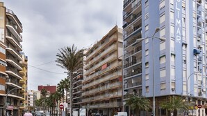 A multi-story building with balconies and a sign that reads "SOLIMAR."