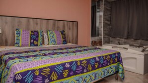 A bedroom with a bed, a window with curtains, a bathtub, and a wooden headboard. - Hot tub studio Ground floor AC (Medellin)