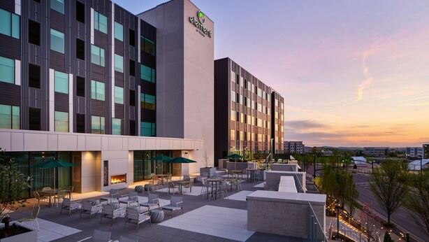 A hotel with a modern exterior, outdoor seating area, and a visible fire feature. - Element by Marriott Nashville Vanderbilt West End (Nashville)