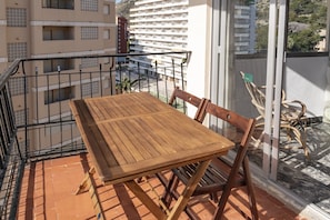 Enjoy a peaceful retreat on the balcony with a seating area.