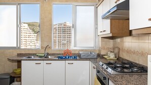 A compact kitchen with a sink, stove, and cabinets. - EL RACO, C-8º-16 (Cullera)