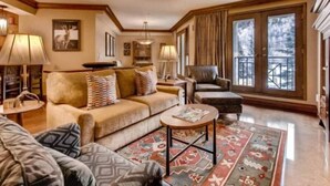 A cozy living room with a sofa, armchairs, a coffee table, and a patterned rug. - Beaver Creek Park Hyatt 2 Bedroom Residence (Avon)