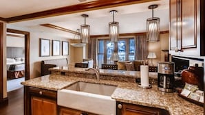 A kitchen with granite countertops, a double sink, and modern pendant lighting. - Beaver Creek Park Hyatt 3 Bedroom Residence (Avon)