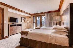 A hotel room with two beds, a TV, a dresser, and a window with a view. - Beaver Creek Park Hyatt 3 Bedroom Residence (Avon)