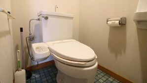 A small bathroom with a toilet, a bidet, and a toilet paper holder. - Hikari no Yado - Detached house for rent in Anan City, Tokushima Prefecture (徳島県)