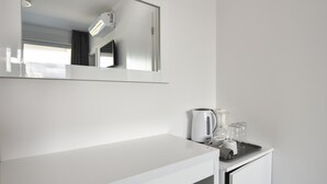 A modern bathroom with a white vanity, a mirror, a towel rack, and a towel dispenser. - Mare Room with Balcony and Shared Pool (Novalja)