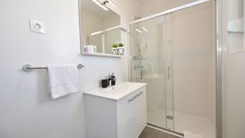 Shower, hair dryer, towels, toilet paper