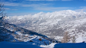 A snow-covered mountain landscape with a clear sky.