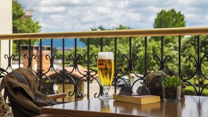 Una mesa con una jarra de cerveza, un libro, un casco y una planta.