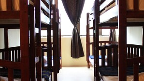 A corridor with bunk beds, wooden railings, and a curtain at the end. - Serenity Hostels (Kuala Lumpur)