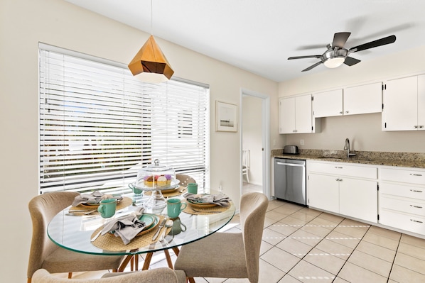 Enjoy meals in the well-appointed kitchen and dining area with a glass-top table and comfortable chairs.