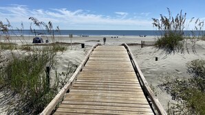 A wooden boardwalk leading to a beach with sand dunes and sparse vegetation. - Single level Sea Pines home with a hot tub, just a short walk to the beach! (Hilton Head)