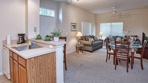 A compact living space with a kitchen, dining area, and seating area. - Great location 4Bed 3bth Townhouse with kids themed room (Kissimmee)