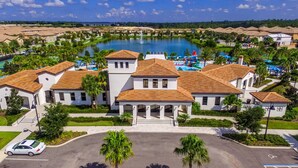 A resort with a central building, a swimming pool, and a parking area. - Amazing New TownHome 5 Bdr 4,5 Bath with Pvt Pool and Access to Clubhouse,15min from Disney (Kissimmee)